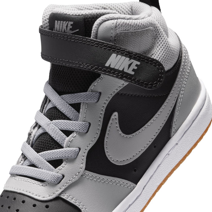 Kids sneaker collar and side detail with black heel strap, light gray laces, Nike branding.