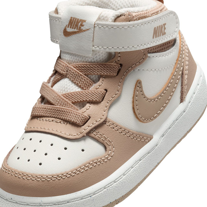 Toddler high-top sneaker close-up with Nike text, swoosh, stitched perforations