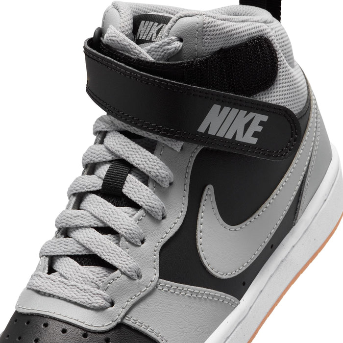 Youth sneaker upper close-up: gray laces and mesh with black Nike heel panel.
