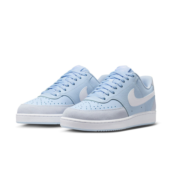Pair of light blue low-top sneakers with white Swoosh and lace-up front.