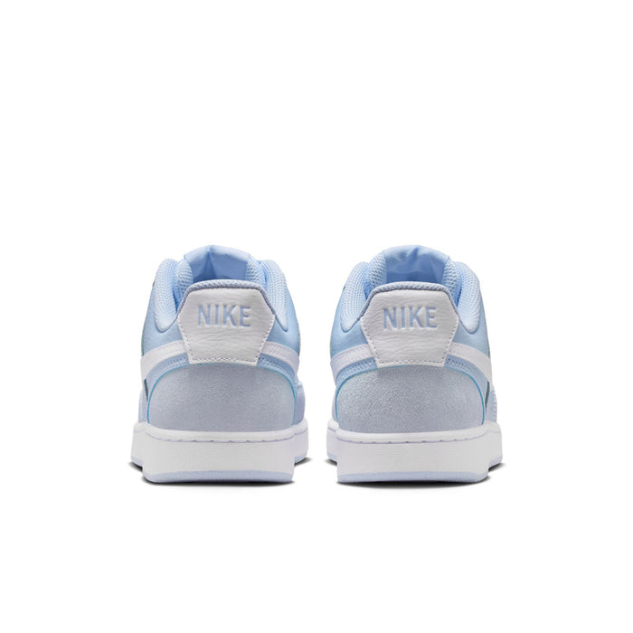 Back view of light blue low-top sneakers with Nike heel tab and white sole.