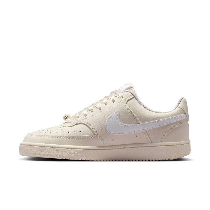 Women’s low-top cream sneakers with Nike light blue swoosh and lace-up front