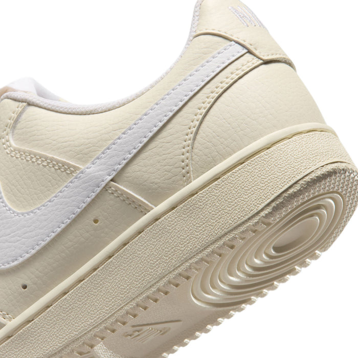 Side close-up of cream leather women’s Nike sneakers with light blue swoosh panel