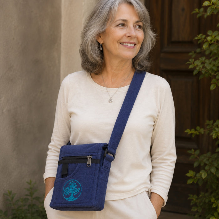 Woman with a blue crossbody bag standing outdoors