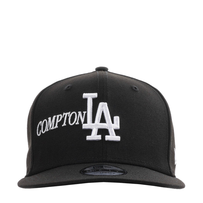 Black baseball cap with white Compton lettering and Los Angeles LA logo on front