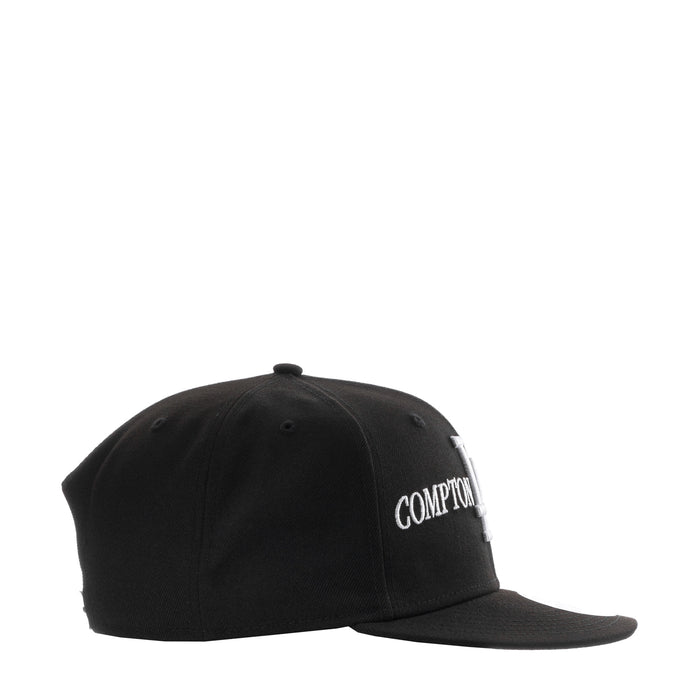 Black baseball cap with side embroidery reading “COMPTON”