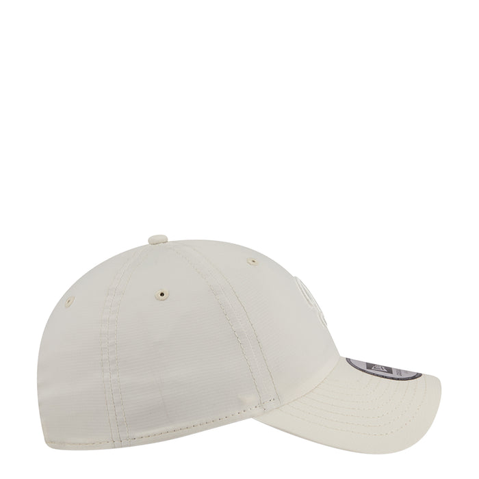 Light cream ripstop strapback cap, side view with curved brim and eyelets