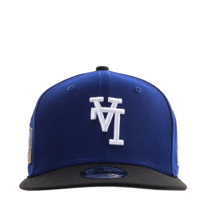 Royal blue baseball cap with white upside-down logo and black brim