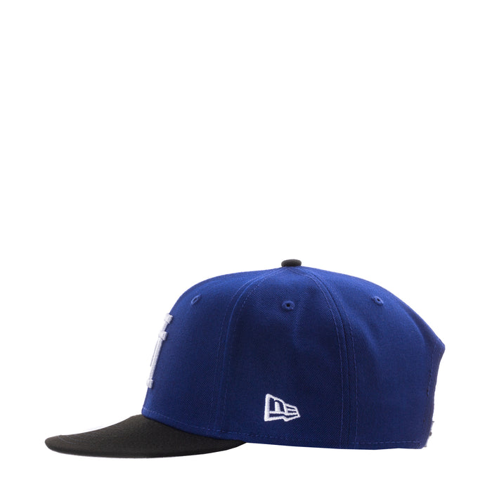 Royal blue baseball cap with small white New Era logo and black brim