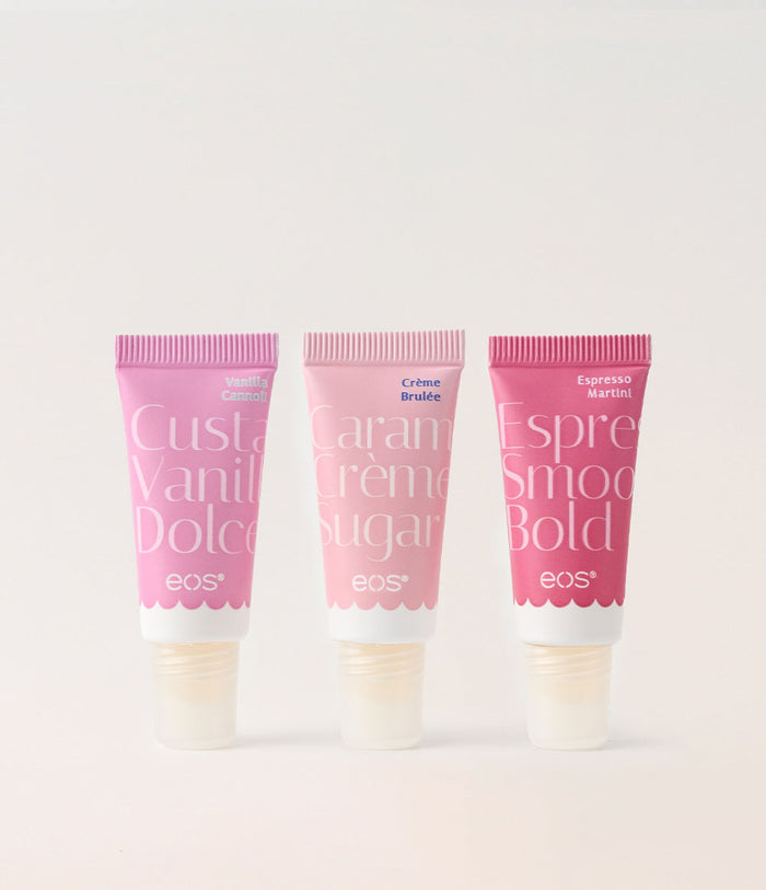 Three EOS lip balm tubes with different flavors on a light gray background