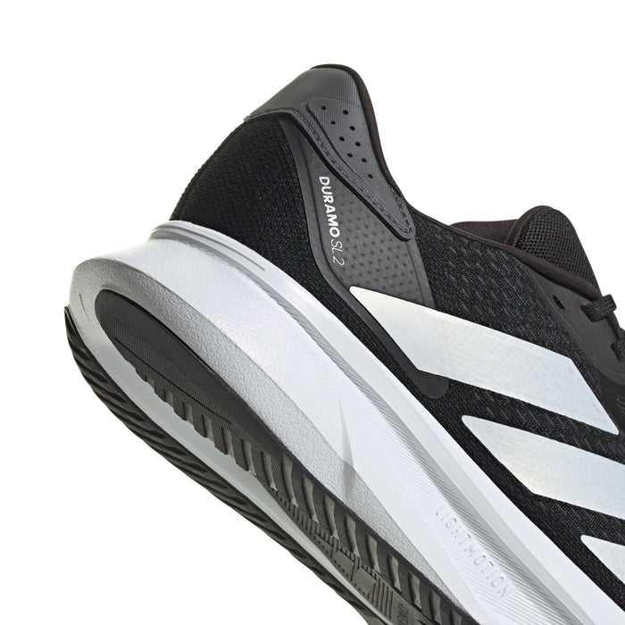 Black mesh upper running sneaker with lace-up front and white stripe detail