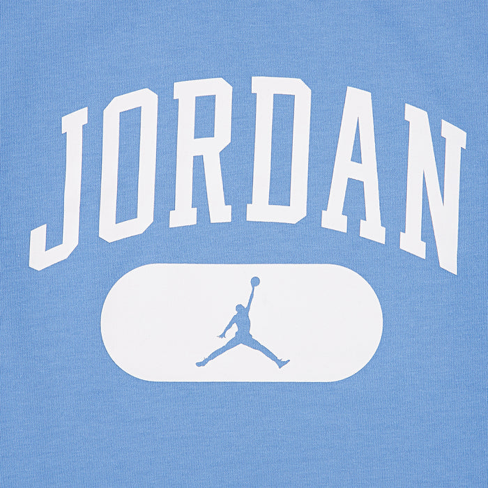 Youth blue Jordan logo graphic close-up with white oval and jumpman