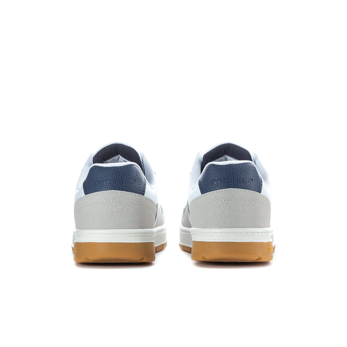 White low-top sneakers with navy heel accents and gum rubber heel sole.