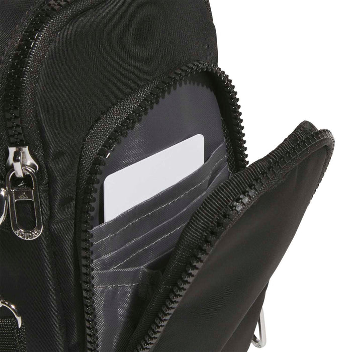 Black crossbody pouch close-up of interior card slots and zippered pocket