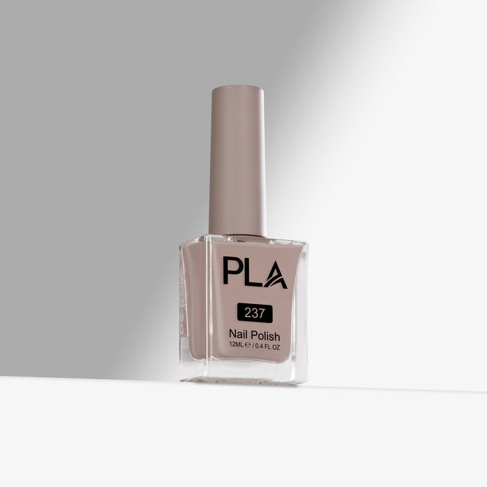 PLA nail polish bottle with gray polish on a gray background