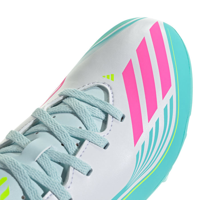 Kids soccer cleat toe/side close-up: white upper with teal lines and pink stripes