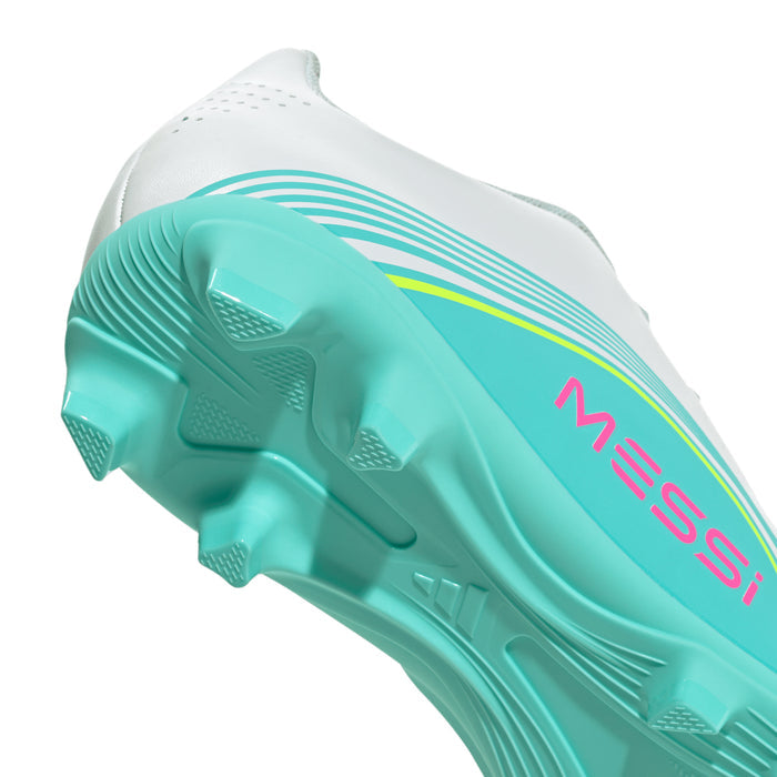 Kids soccer cleat outsole close-up: teal sole with FG studs and Messi mark