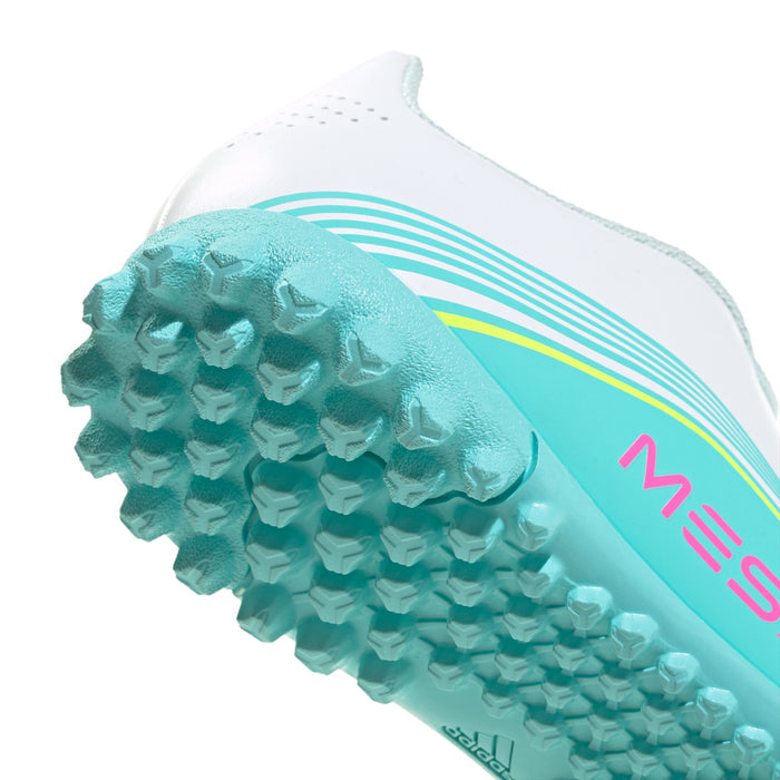 Youth soccer cleat toe close-up showing aqua textured studs on the turf outsole