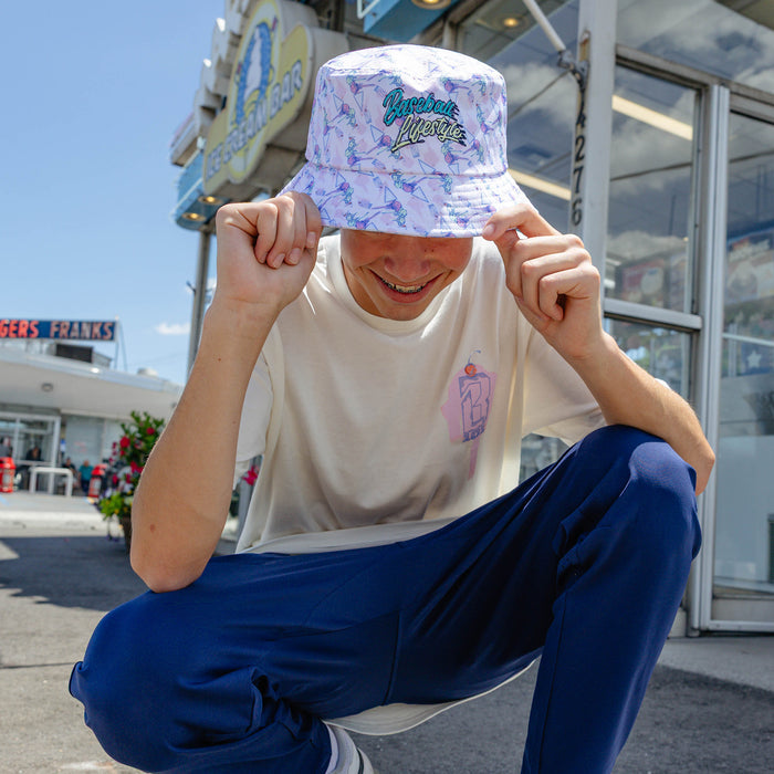 Adult model wearing hat with "Fastball Scoops Bucket" design