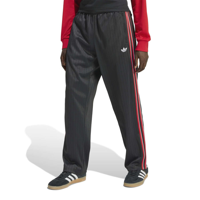 Black track pants with elastic waist, small logo, and red-and-white side stripes