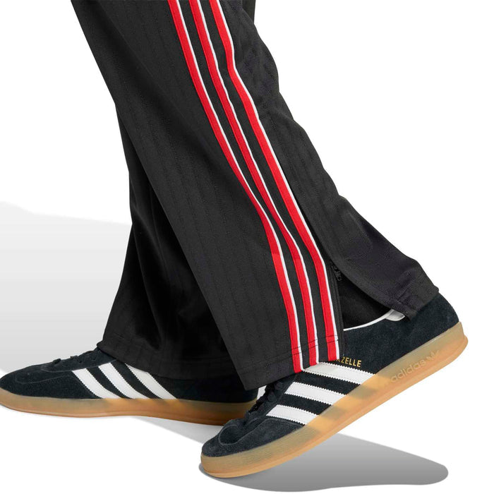 Black track pants with red-and-white side stripes and ribbed ankle opening