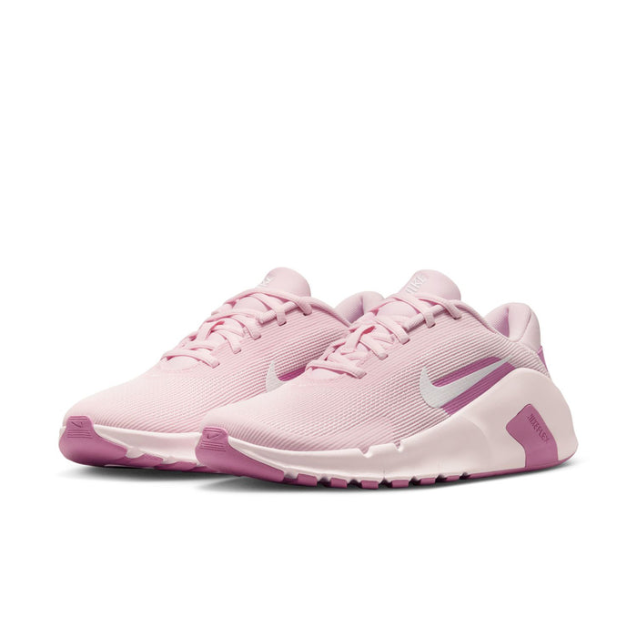 Women’s pink and white training sneaker pair, lace-up upper with Nike Swoosh.