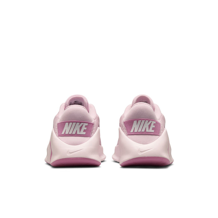 Women’s pink and white training sneakers with Nike heel tab, rear view.