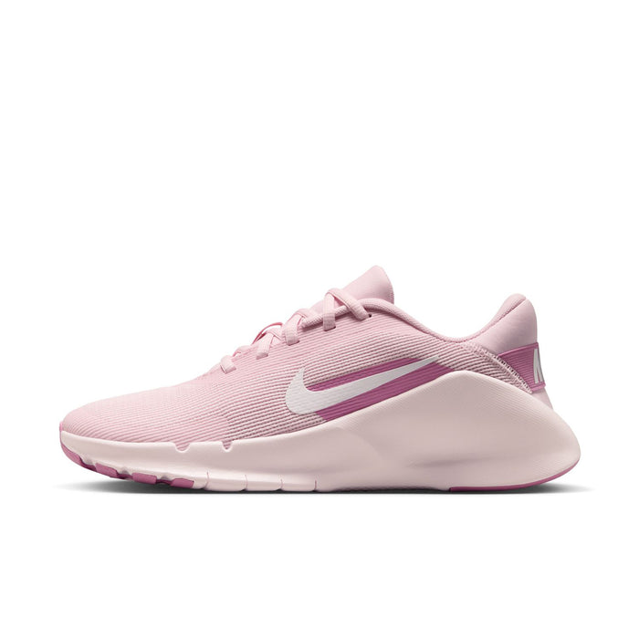 Women’s pink and white training sneaker, side profile with Nike Swoosh and laces.