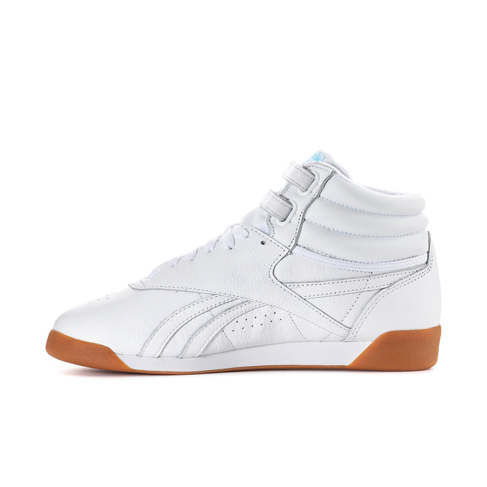 White high-top sneakers, side view with lace-up, strap, gum outsole