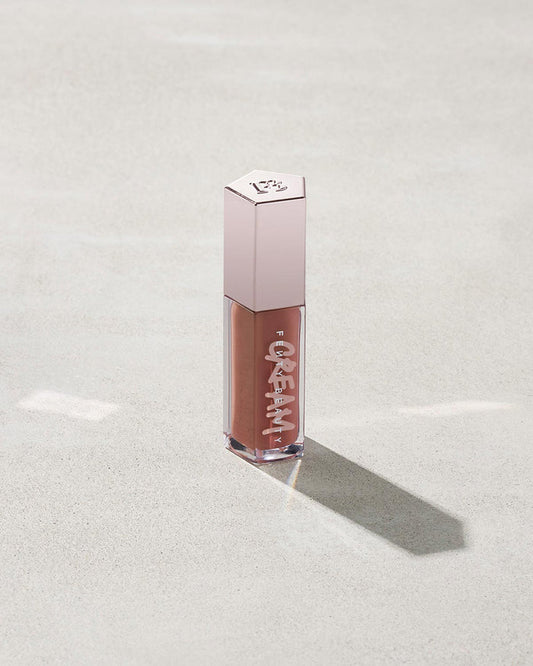 tube of Fenty Beauty Gloss Bomb Cream Color Drip Lip Cream lip gloss shown in shade Fenty Glow