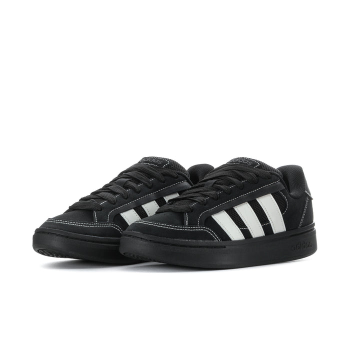 Pair of black low-top sneakers with white triple stripe panels and black laces