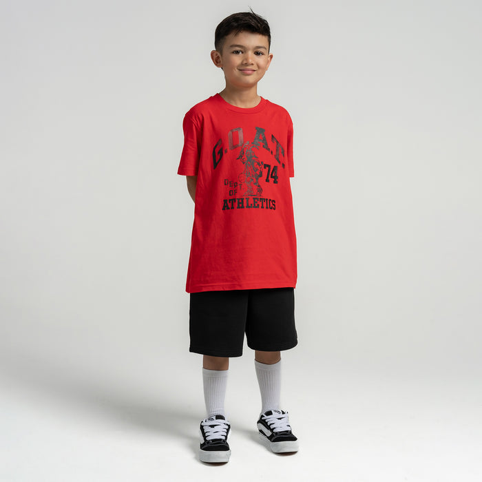Red youth graphic T-shirt worn with black shorts and white socks