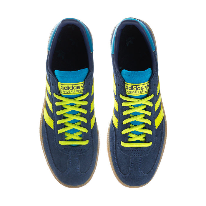 Pair of men's sneakers with neon laces, navy upper, teal lining, and branding