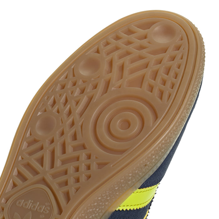 Close-up of men's gum outsole tread with geometric pattern and logo