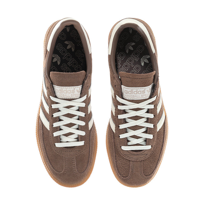 Brown suede sneakers with white laces and striped tongue detail