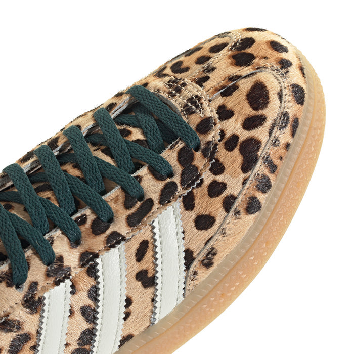 Women's adidas sneaker close-up, leopard canvas with teal laces and white triple stripes