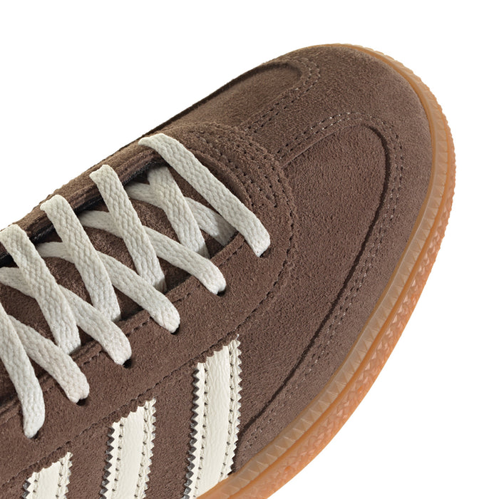 Close-up of brown suede upper with white laces and side stripe detail