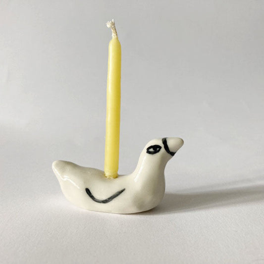 Ceramic duck cake topper candle holder with yellow candle; white duck with black eyes
