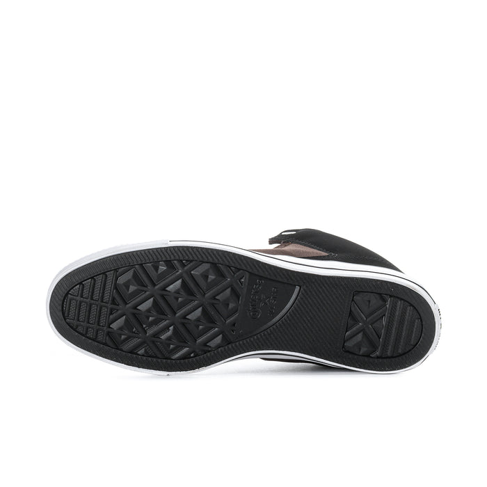 Outsole of black and white mid-top sneakers with textured tread and star pattern