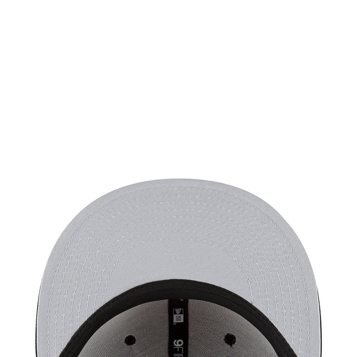 Light gray baseball cap top panel close-up with black inner brim