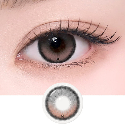 A close-up shows a human eye wearing i-Sha Reborn Red 1-Day Rosy Cream (10pk) contacts by i-Sha, featuring a large gray lens with a dark outer ring and subtle ribbon-lace pattern. Below is the lens design on a white background.