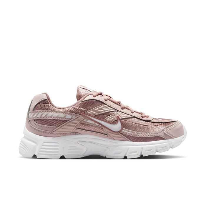 Women's pink lace-up running sneakers with white sole and swoosh details