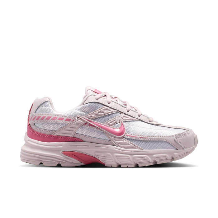 Light gray and pink women's sneaker with lace-up front and Nike logo