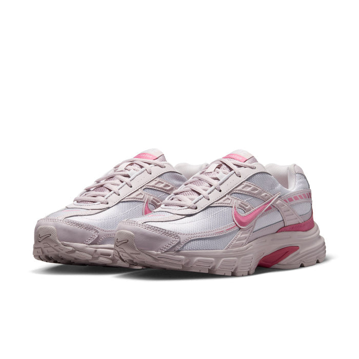Light gray and pink women's sneaker, angled view of lace-up upper