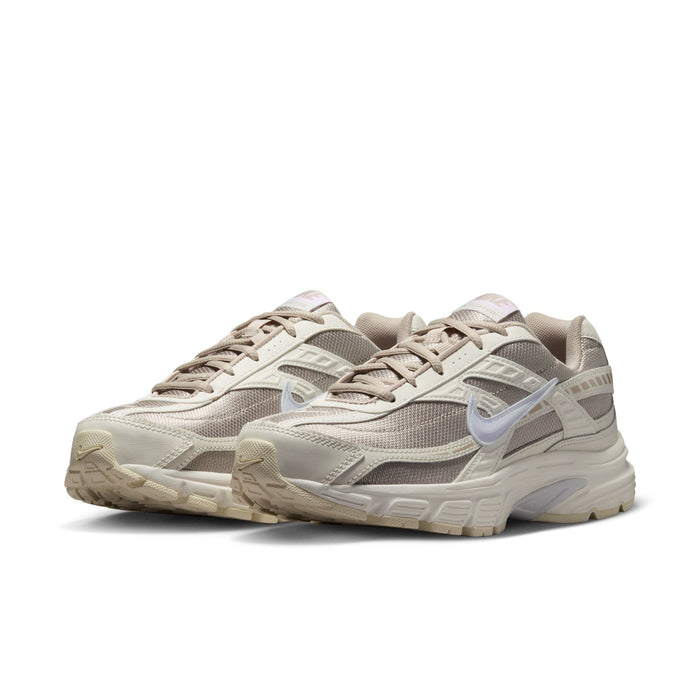 Women's cream and tan running sneakers with lace-up front and cushioned sole