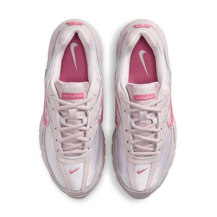 Pair of light gray and pink women's sneakers with laces and tongue branding