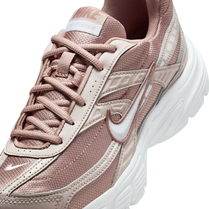 Close-up of dusty pink mesh sneakers with lace-up and side swoosh logo