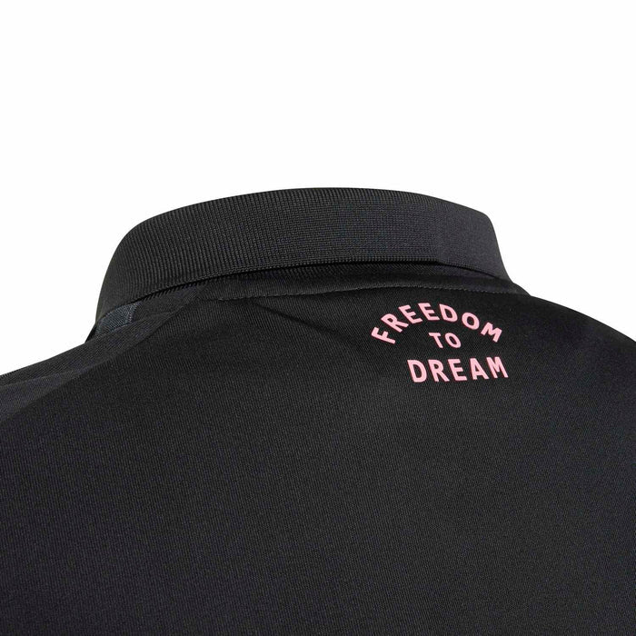 Youth black soccer jersey back collar with pink text: Freedom to Dream