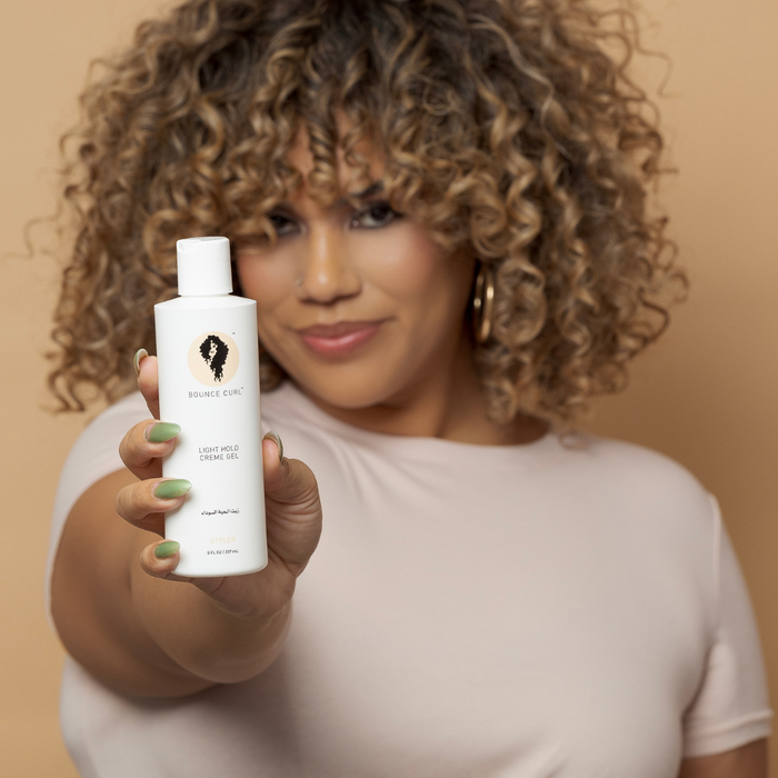Image of model holding Light Hold Creme Gel