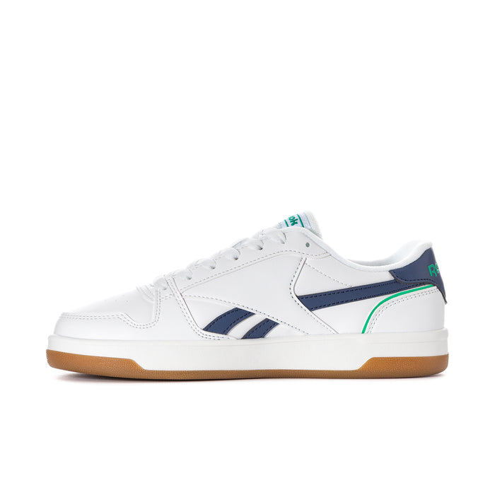 Women's white sneaker side view with navy overlays, green stripe, gum sole